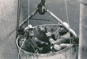 Two miners being rescued by a bucket from the mine disaster November 20, 1968,  The photographer is unknown